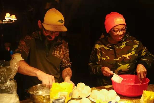 HOC members in the the kitchen cooking the game that was caught.