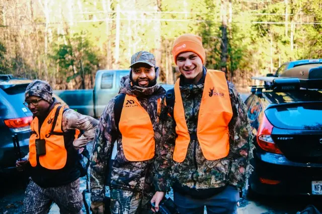 HOC members with bows wearing orange vests.